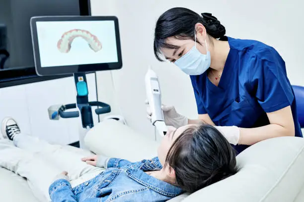 asia nurse examining teeth for patient