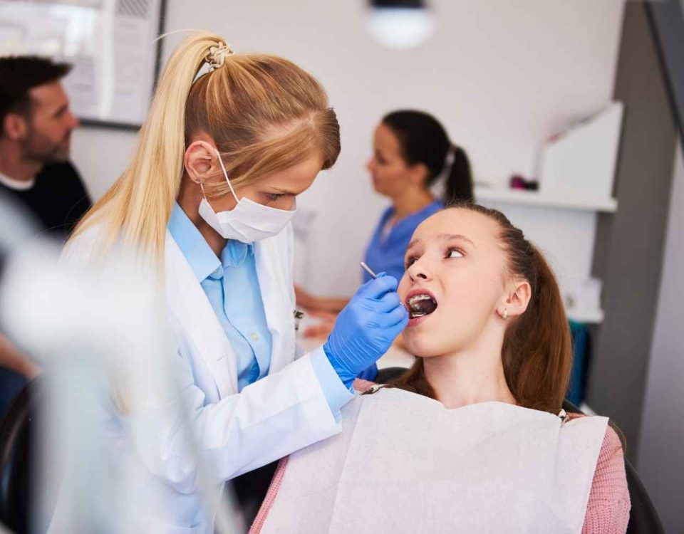 female patient having procedure done dentist